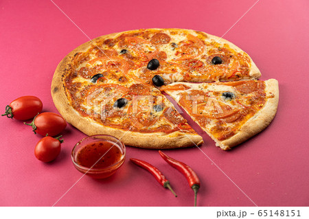 pizza close-up, isolated, against a colored background. whole pizza  65148151