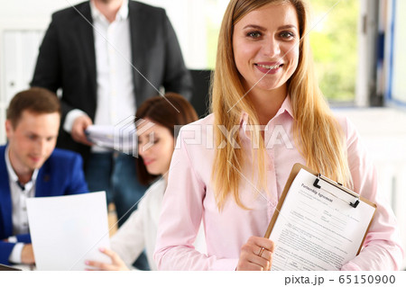 Beautiful smiling cheerful girl at workplace look in camera 65150900