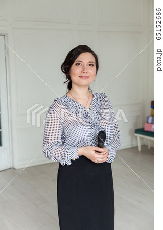 Portrait of a beautiful businesswoman Asian woman talking on the microphone sings Portrait of a beautiful businesswoman Asian woman talking on the microphone sings 65152686
