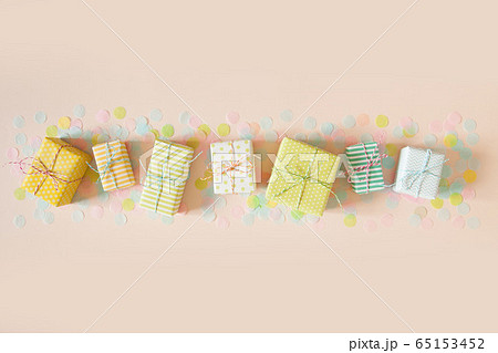 Gift boxes and pastel color confetti. Pink background. 65153452