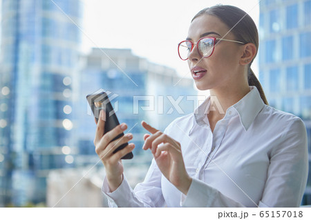 Female real estate agent talking by mobile phone 65157018