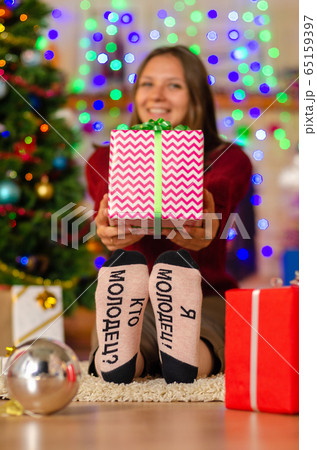 a happy girl in funny socks with the inscription 65159397
