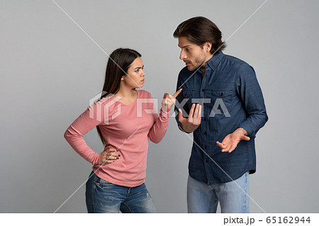 Young couple arguing. Angry millennial girl blaming her boyfriend 65162944