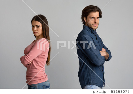 Break Up. Offended man and woman standing back to back after arguing 65163075