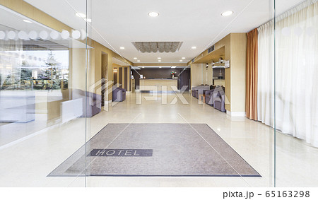 Open glass door at entrance of modern hotel Open glass door at entrance of modern hotel 65163298