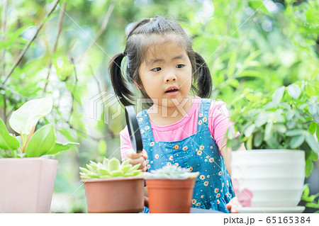 A child playing in the garden A child playing in the garden 65165384