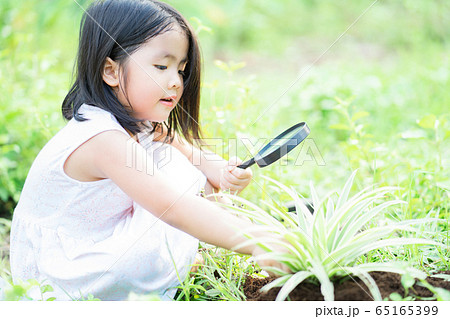 A child playing in the garden A child playing in the garden 65165399