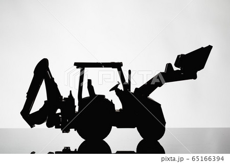 backhoe tractor silhouette on grey background 65166394