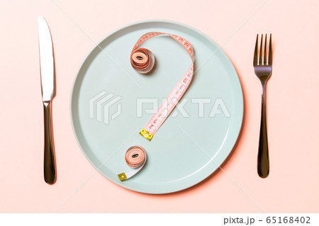 Question mark made of measuring tape on round Question mark made of measuring tape on round 65168402