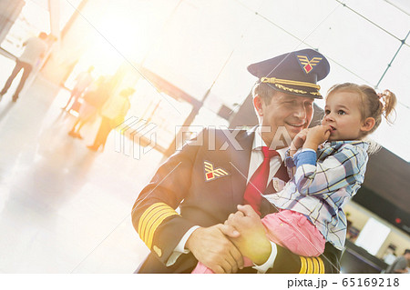 Portrait of mature pilot carrying cute little Portrait of mature pilot carrying cute little 65169218