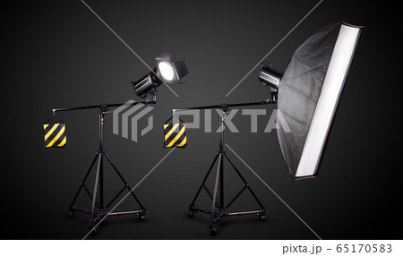 Photo studio lighting stands with flash and softbox isolated on the black. Photo studio lighting stands with flash and softbox isolated on the black. 65170583