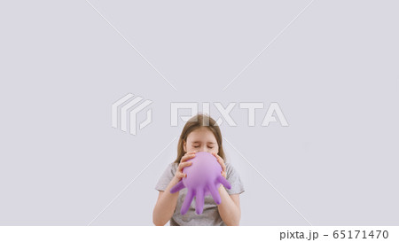 Young kid play with purple protective medical glove 65171470