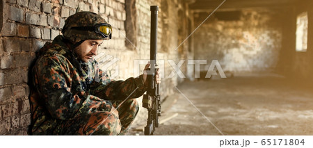 A thoughtful soldier, resting from a military operation A thoughtful soldier, resting from a military operation 65171804
