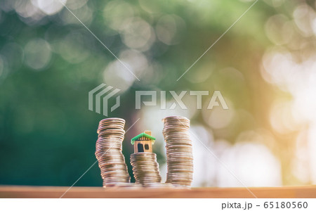 House placed on coins. planning savings money of 65180560