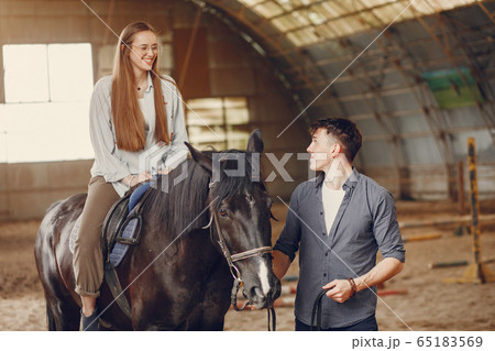 Cute loving couple with horse on ranch Cute loving couple with horse on ranch 65183569