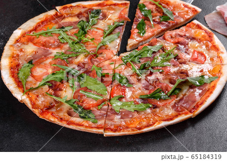 Fresh pizza baked in oven with arugula Fresh pizza baked in oven with arugula 65184319