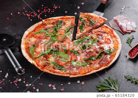 Fresh pizza baked in oven with arugula Fresh pizza baked in oven with arugula 65184320