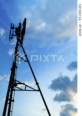 Silhouette of telecommunication tower of 4G and 5G cellular, mobile and internet station tower in cloudy sky background, vertical view. Silhouette of telecommunication tower of 4G and 5G cellular, mobile and internet station tower in cloudy sky background, vertical view. 65188183