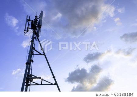 Silhouette of telecommunication tower of 4G and 5G cellular, mobile and internet station tower in cloudy sky background. Silhouette of telecommunication tower of 4G and 5G cellular, mobile and internet station tower in cloudy sky background. 65188184