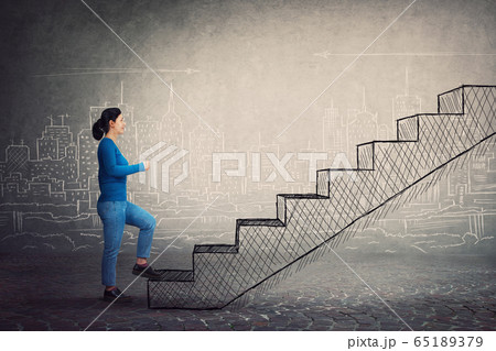 Motivated and confident young woman hurry to climb Motivated and confident young woman hurry to climb 65189379