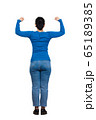 Rear view woman full body showing and flexing arm 65189385