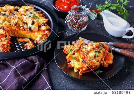 Tamale pie on a black baking dish, close-up Tamale pie on a black baking dish, close-up 65189493