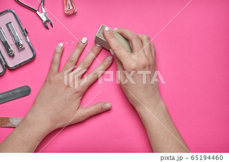 Overgrown nails with an old cracked gel polish. Self-removal of old gel polish from nails with a nail file. Overgrown nails with an old cracked gel polish. Self-removal of old gel polish from nails with a nail file. 65194460