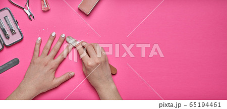 Overgrown nails with an old cracked gel polish. Self-removal of old gel polish from nails with a nail file. Overgrown nails with an old cracked gel polish. Self-removal of old gel polish from nails with a nail file. 65194461