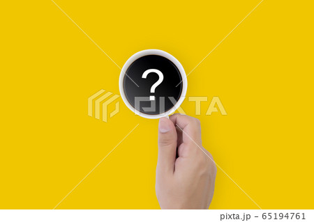Hand holding cup of hot coffee with question mark isolated on yellow background Hand holding cup of hot coffee with question mark isolated on yellow background 65194761