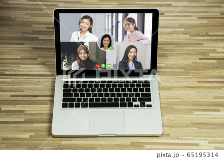 Asian business people team talking to her colleagues in company video conference. Group of business women using laptop for online meeting with video call while working from home Asian business people team talking to her colleagues in company video conference. Group of business women using laptop for online meeting with video call while working from home 65195314
