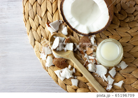 Coconut oil and fresh coconuts on the wooden table Coconut oil and fresh coconuts on the wooden table 65196709