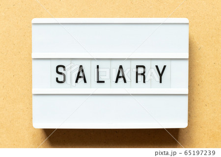 Lightbox with word salary on wood background 65197239