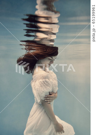Portrait of a girl in a white dress underwater 65199961