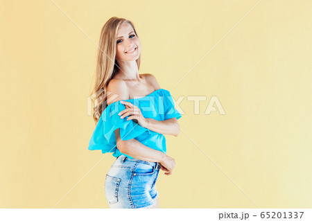 blonde girl in a blue dress, on a yellow background 65201337