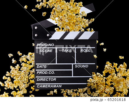 Flying popcorn and film clapper board isolated on black background Flying popcorn and film clapper board isolated on black background 65201618