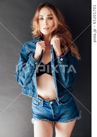 Portrait of a beautiful fashionable woman in jeans and black lingerie style 65201701
