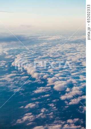 flying above the clouds at sunset landscape from an airplane flying above the clouds at sunset landscape from an airplane 65202333