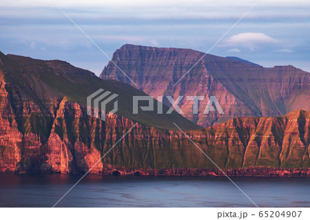 Incredible view of Faroe islands, glowing by sunset light Incredible view of Faroe islands, glowing by sunset light 65204907