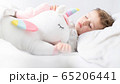 Baby girl sleeping with her unicorn. Close up. 65206441
