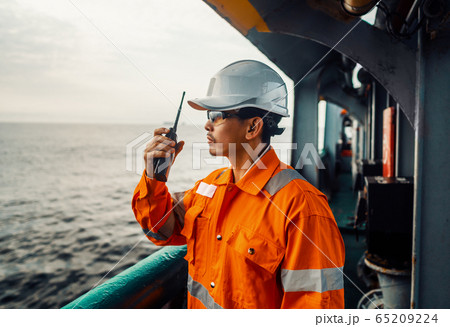 Filipino deck Officer on deck of vessel or ship , wearing PPE personal protective equipment Filipino deck Officer on deck of vessel or ship , wearing PPE personal protective equipment 65209224