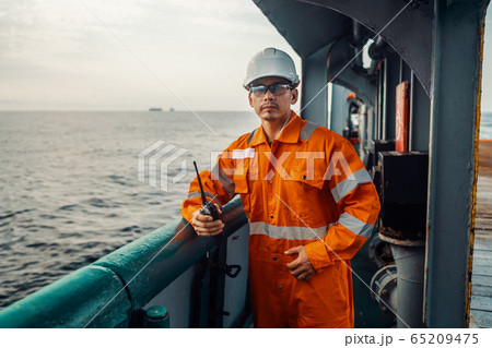 Filipino deck Officer on deck of vessel or ship , wearing PPE personal protective equipment 65209475