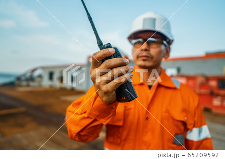 Filipino deck Officer on deck of vessel or ship , wearing PPE personal protective equipment 65209592