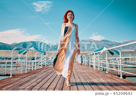 Woman on the pier. 65209692