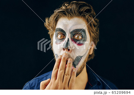 Masked man of the day of death on Halloween 65209694