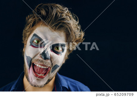 Masked man of the day of death on Halloween 65209709