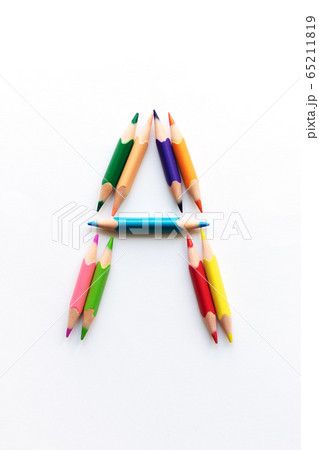 Letter A composed of colored pencils on white paper 65211819