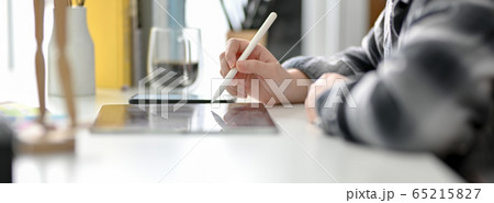 Side view of female graphic designer working on Side view of female graphic designer working on 65215827