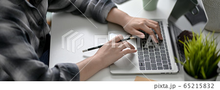 Cropped shot of female college student working at 65215832