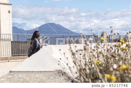 Rear view of thoughtful woman looking away while 65217748