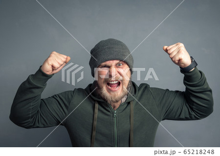 Portrait of a bearded guy in a hoodie and hat with 65218248
